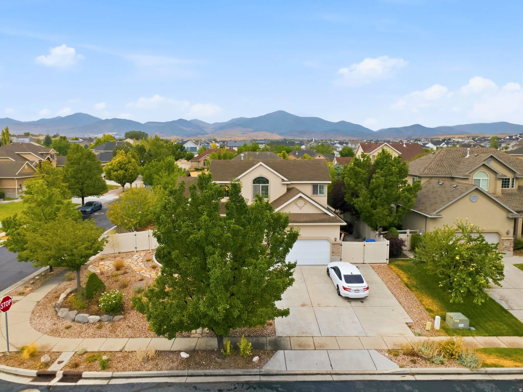 Charming residential home situated on a professionally landscaped lot featuring mature trees, drought-resistant plantings, and a paved driveway