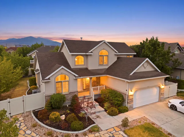 Stucco exterior with stone accents and a multi-level roofline
