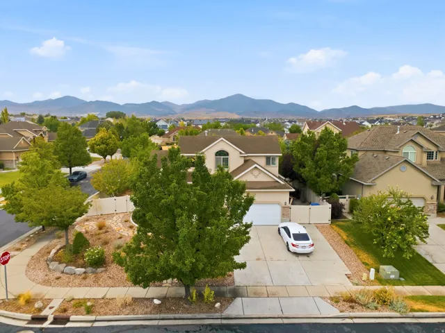 Charming residential home situated on a professionally landscaped lot featuring mature trees, drought-resistant plantings, and a paved driveway