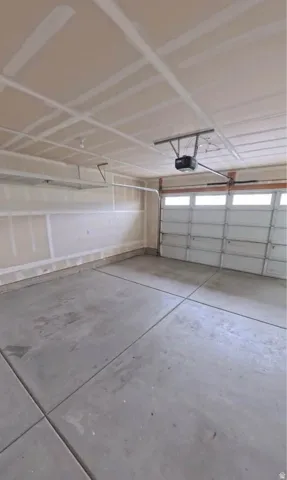 Attached garage featuring a concrete floor and an overhead sectional door