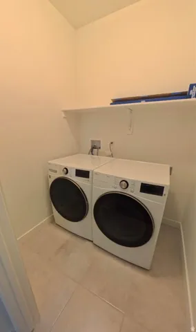 Laundry area featuring a built-in shelf and tile flooring