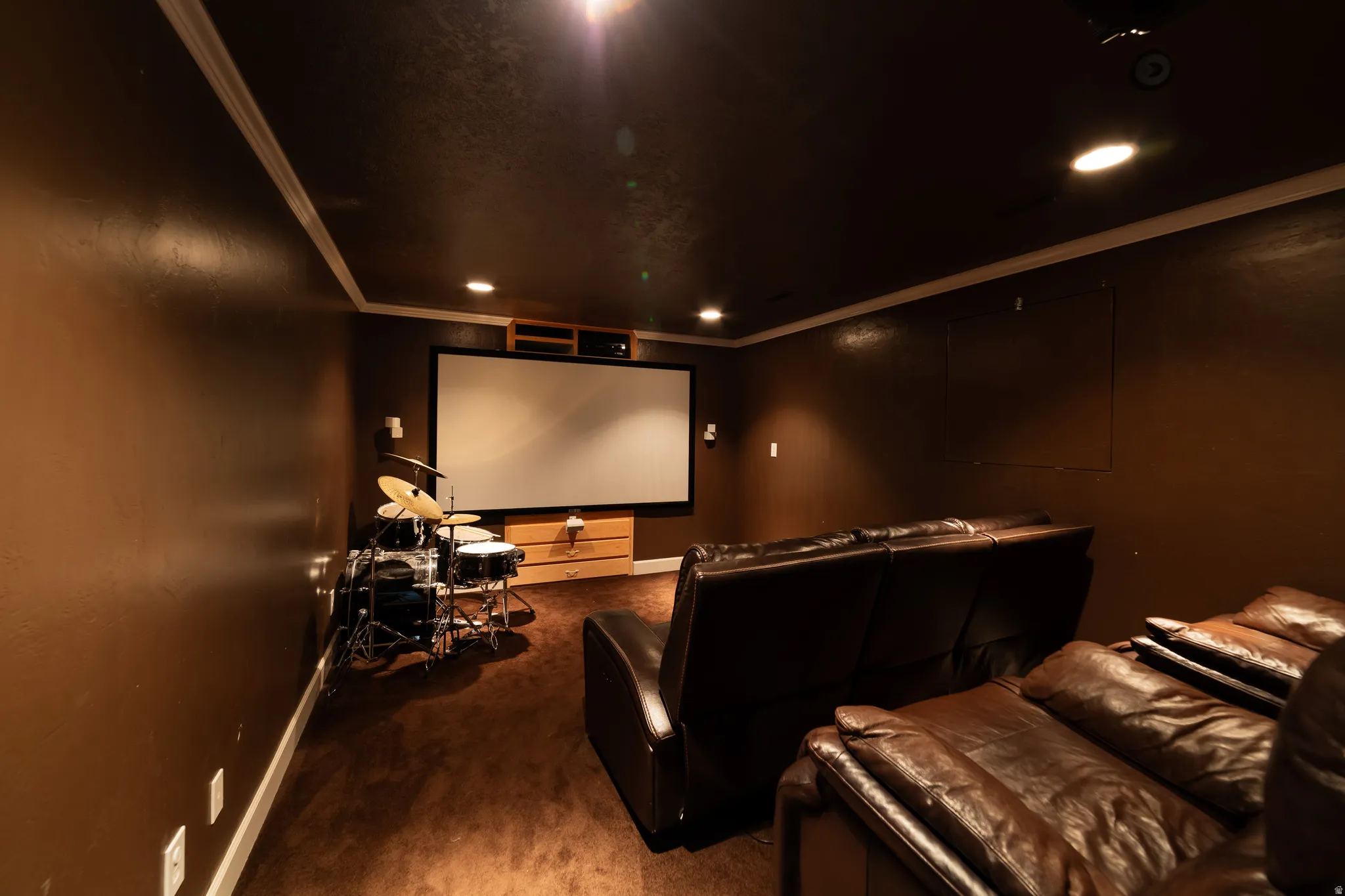 Media room featuring a projector screen, recessed lighting, and crown molding