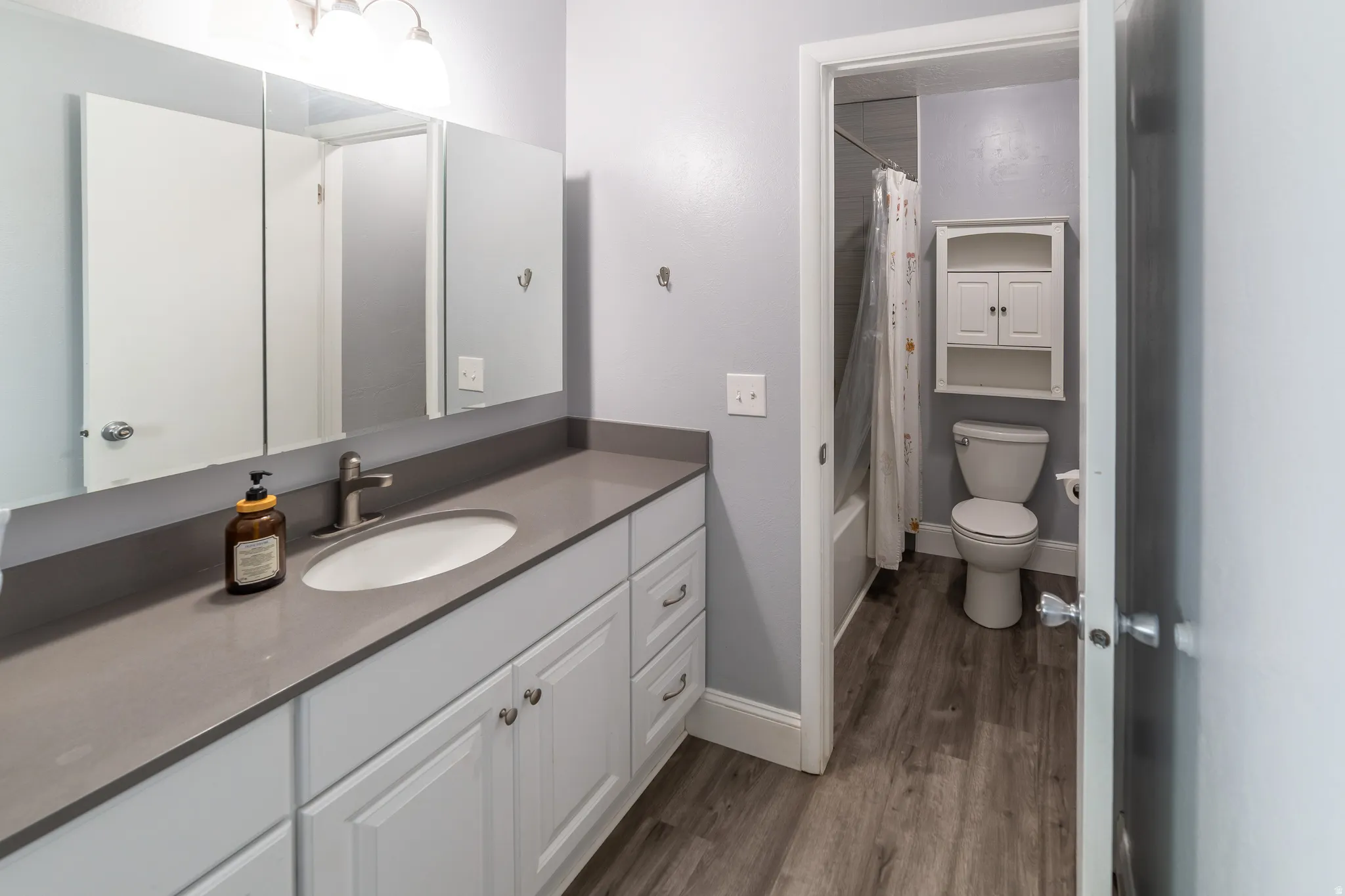 Spacious vanity with an integrated sink, brushed nickel faucet, and under-cabinet storage