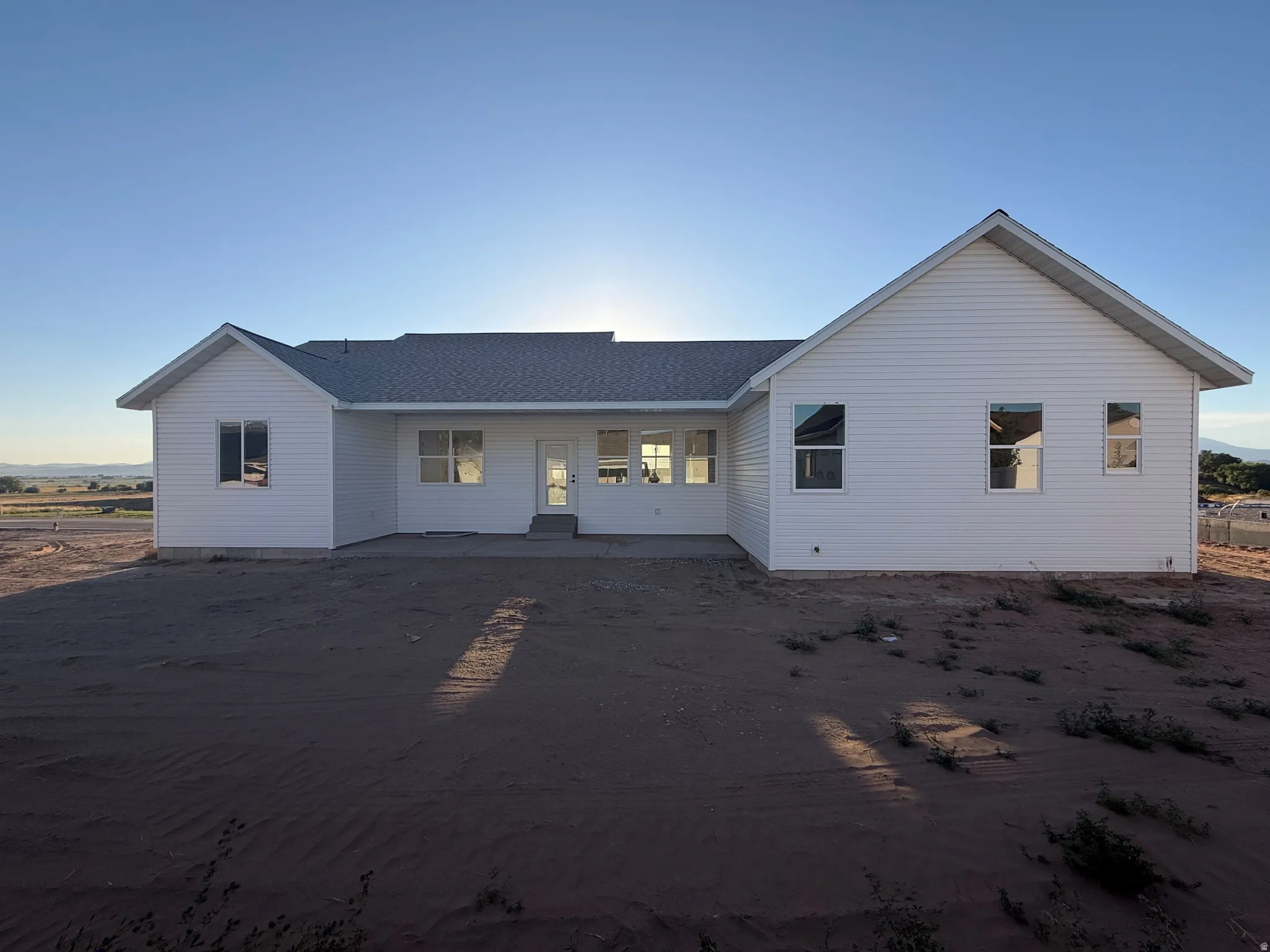 White horizontal siding exterior with a light-colored shingle roof