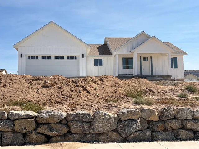 Contemporary white board and batten exterior with horizontal siding accents