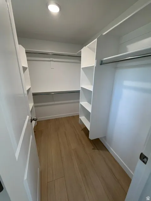 Recessed lighting illuminates wood-finish flooring