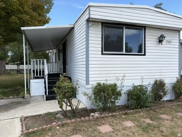 White siding exterior with black trim windows