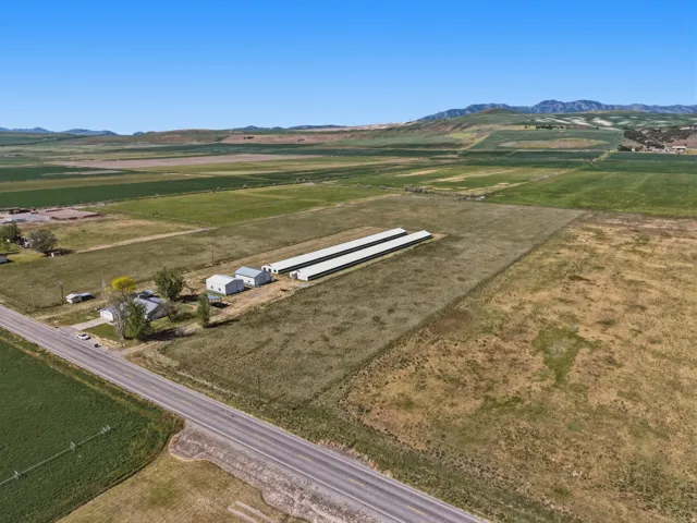Expansive property featuring a main residence, multiple outbuildings, and extensive agricultural structures