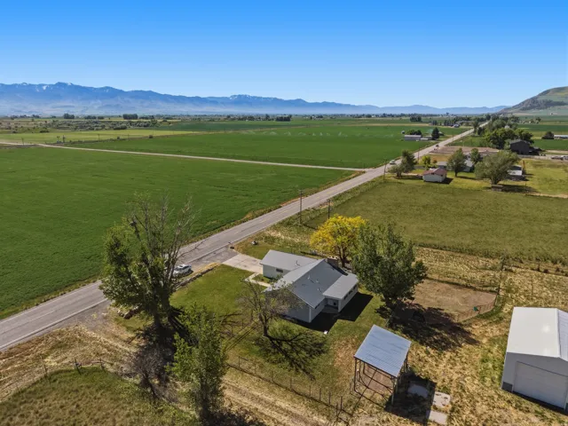 Expansive green fields with distant mountain backdrop