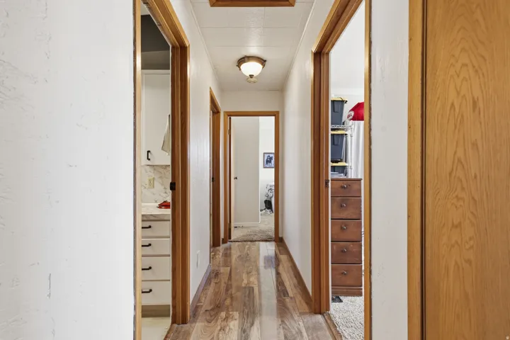 Wood-finish flooring throughout the hallway