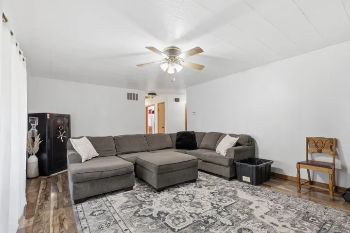 Wood-finish flooring with a ceiling fan overhead