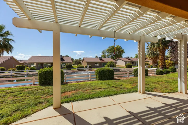 Expansive outdoor patio with a white pergola, offering open-air coverage