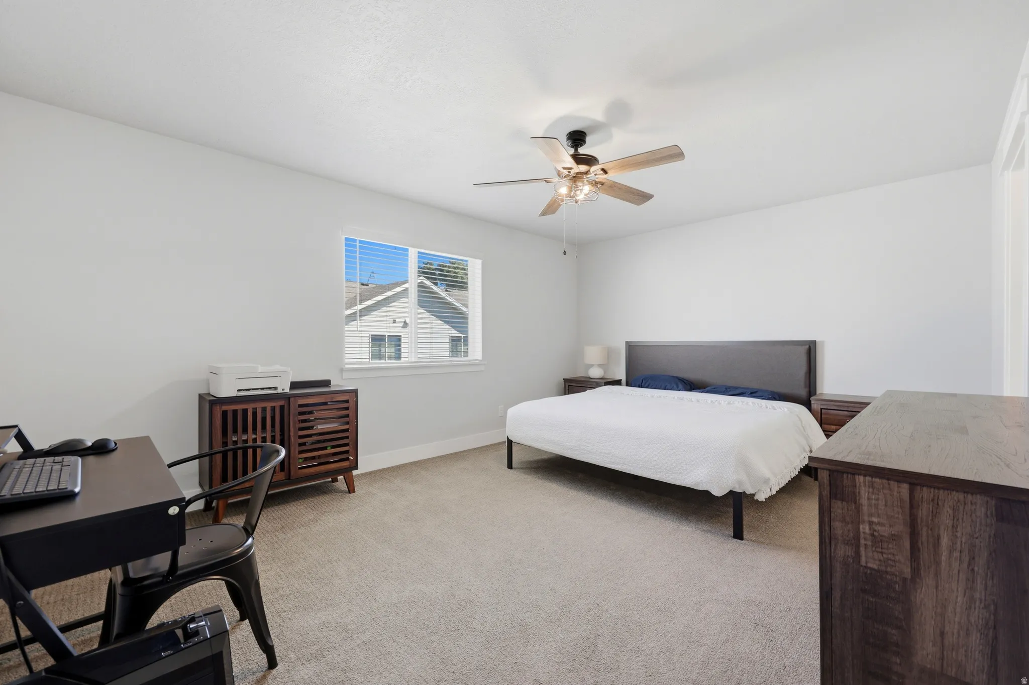 Carpeted flooring, single window with blinds, ceiling fan with integrated lighting, white walls
