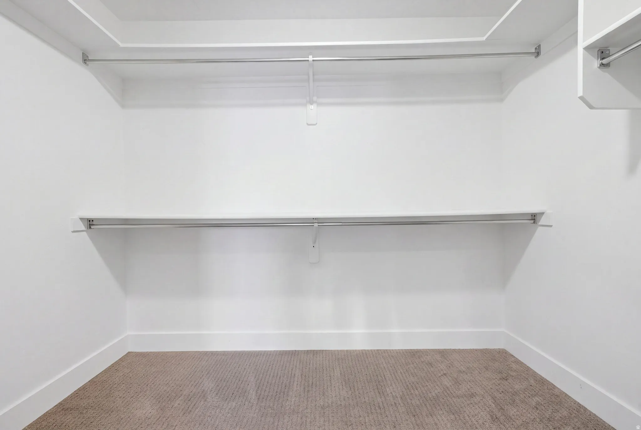 White walls with light-colored carpeting