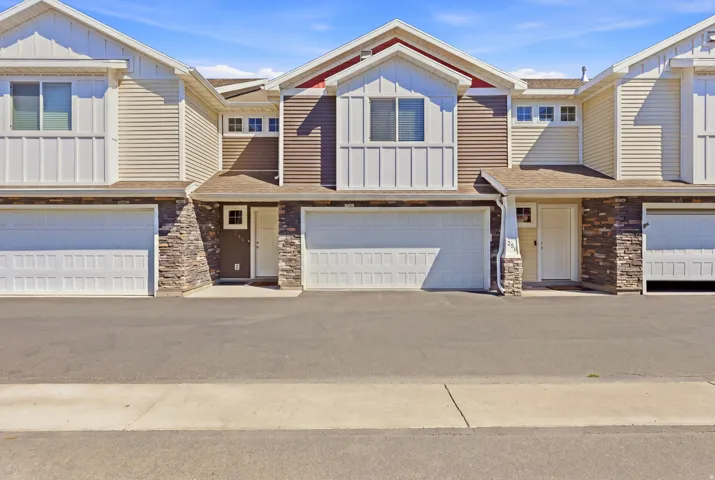 Multi-level facade featuring stone accents, horizontal siding, and a prominent gable