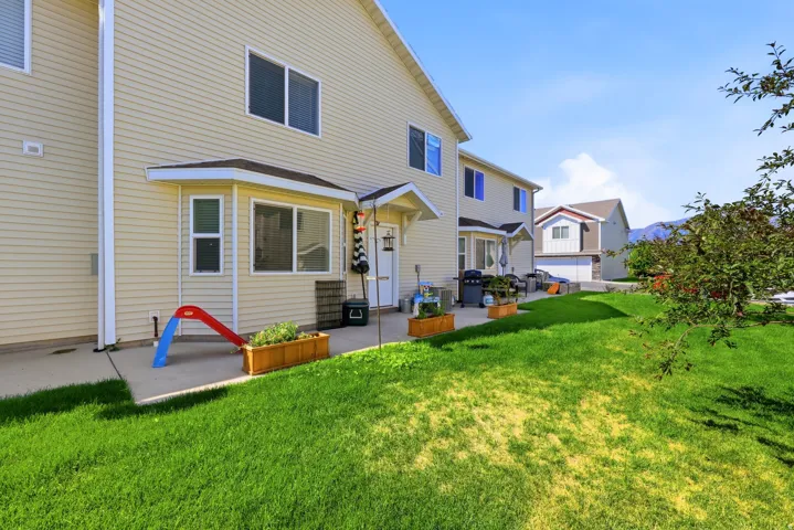 Expansive grass lawn with concrete patio area