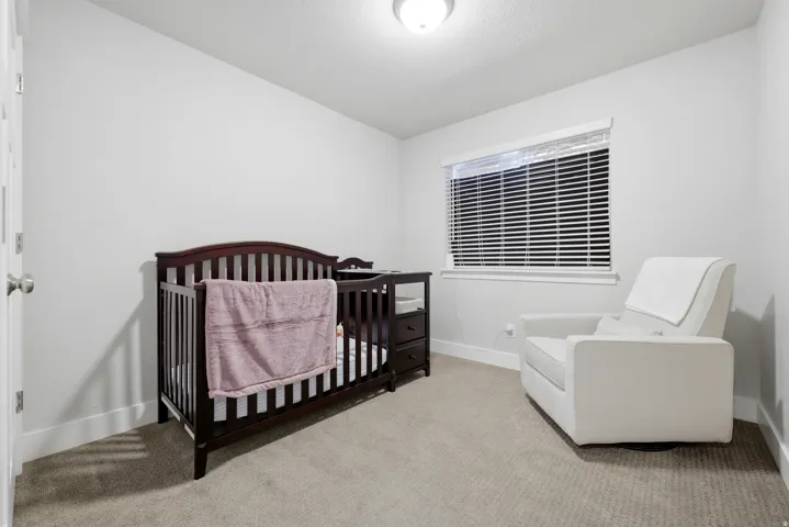 Carpeted flooring, white walls, window with blinds, and flush mount ceiling light