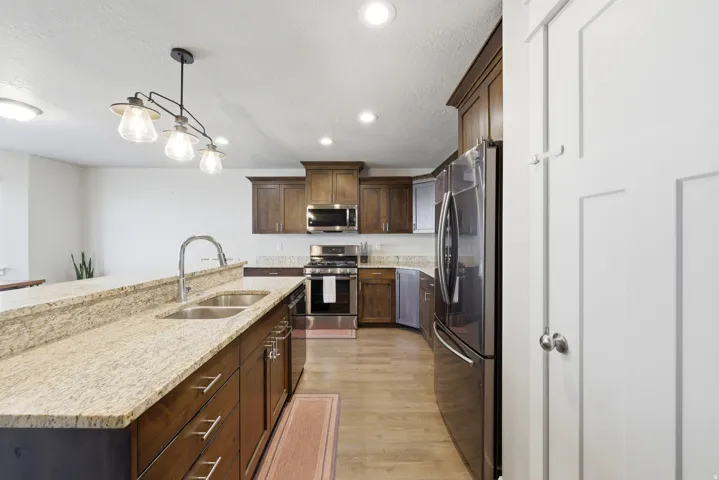 Kitchen with wood-finish flooring, recessed lighting, and a stainless steel appliance suite