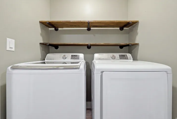 Two wood-finish floating shelves with dark metal supports