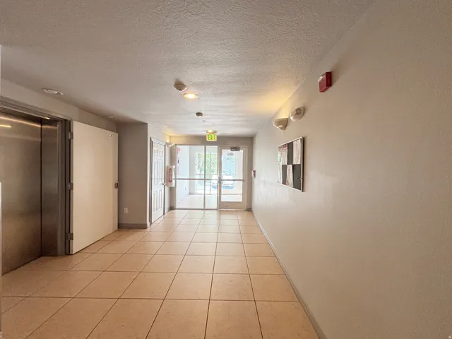 Tile flooring, flush-mounted lighting, recessed lighting, wall-mounted light fixtures, full-light glass doors