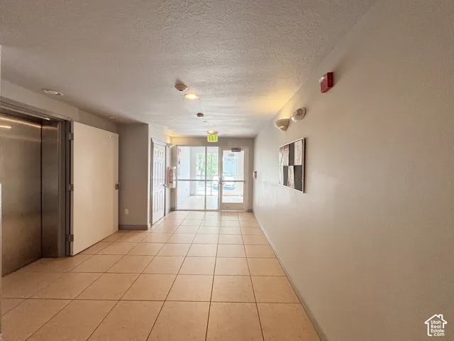 Tile flooring, flush-mounted lighting, recessed lighting, wall-mounted light fixtures, full-light glass doors