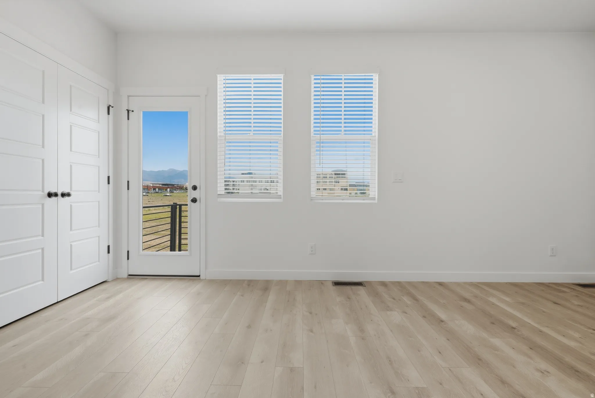 Wood-finish flooring, white walls, and white trim