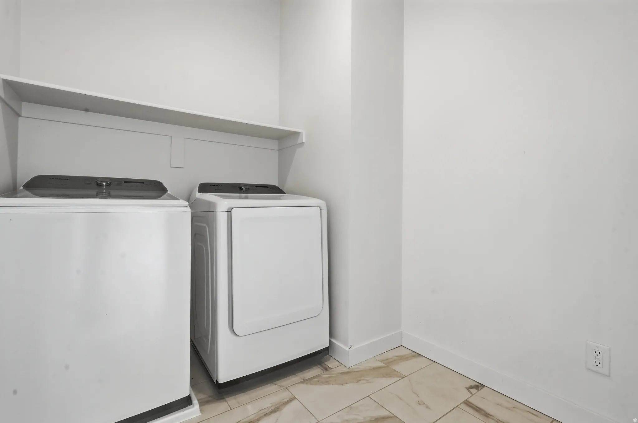 Laundry area featuring a built-in shelf and tile flooring