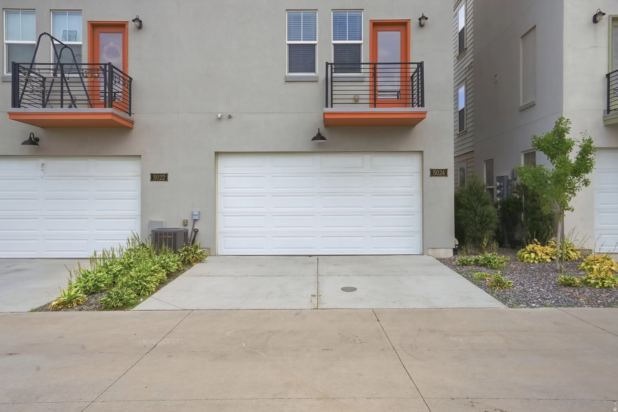 Smooth concrete driveway and attached two-car garage