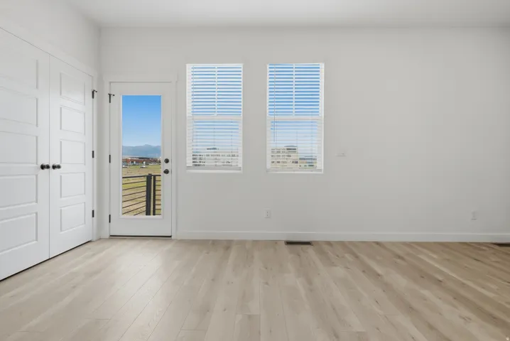 Wood-finish flooring, white walls, and white trim