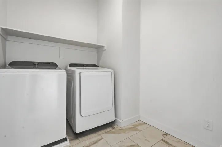 Laundry area featuring a built-in shelf and tile flooring