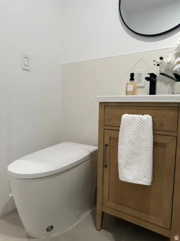 Modern vanity with a light wood finish and cane-front cabinet