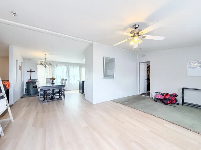 Wood-finish flooring throughout, ceiling fan with integrated lighting, and recessed ceiling lighting