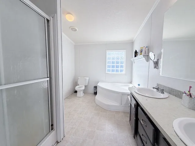 Dual vanity with integrated sinks and dark wood-finish cabinetry