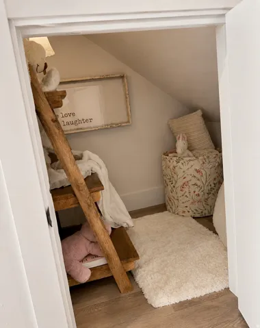 Wood-finish flooring with white baseboards and an angled wall