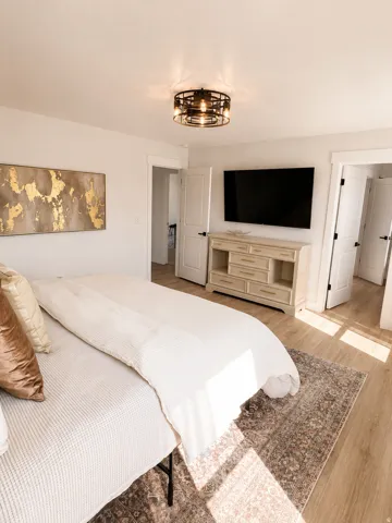 Recessed lighting, wood-finish flooring, white paneled doors, and a decorative semi-flush mount light fixture