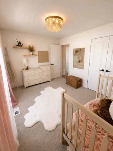 Recessed lighting, wood-finish floating shelves, light-toned carpet, and white paneled doors with matte black hardware