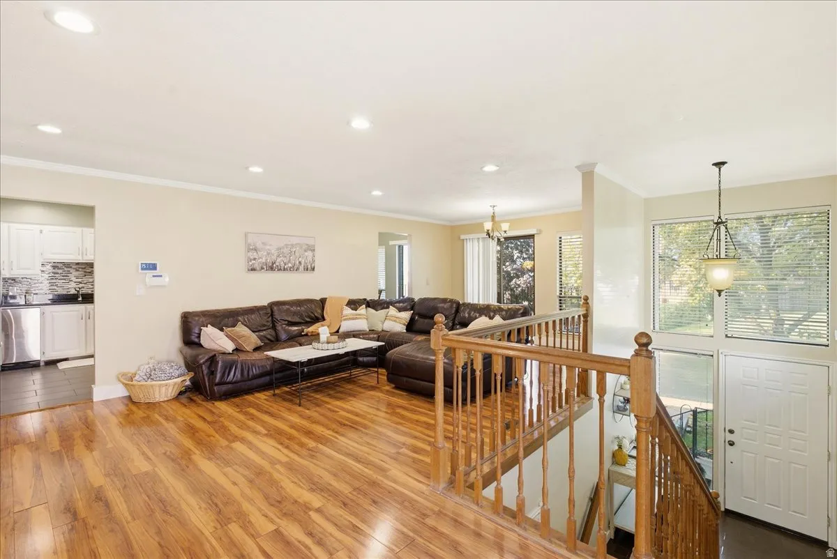 Wood-finish flooring throughout, recessed lighting, and crown molding