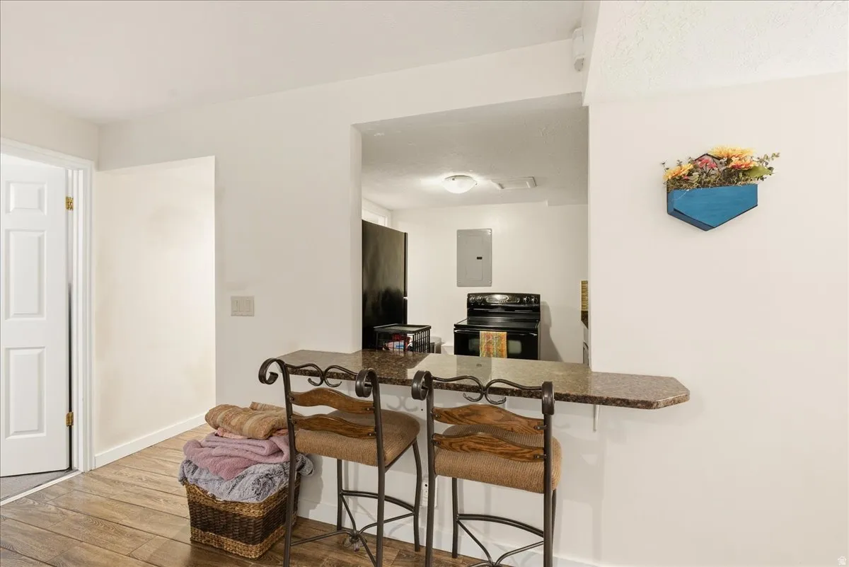 Pass-through window with a breakfast bar featuring a stone-finish countertop