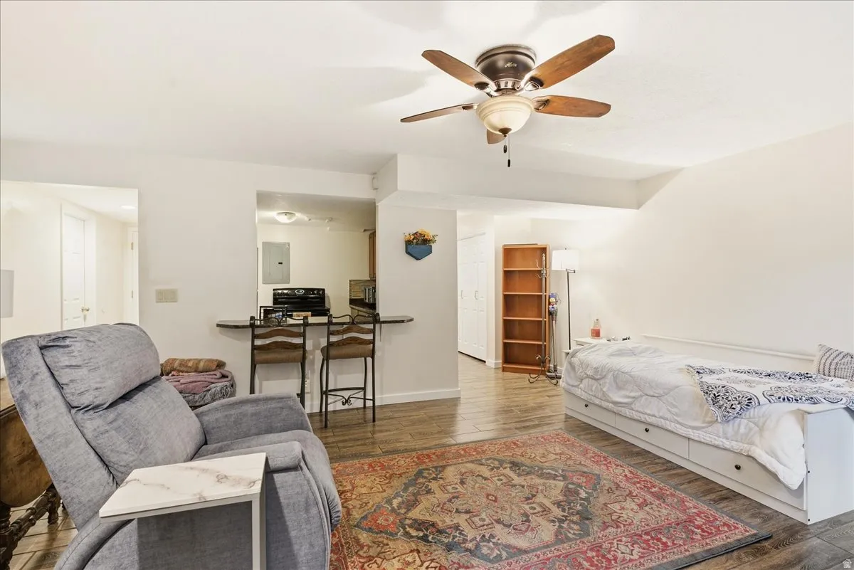 Open-concept living area featuring wood-finish flooring and a ceiling fan