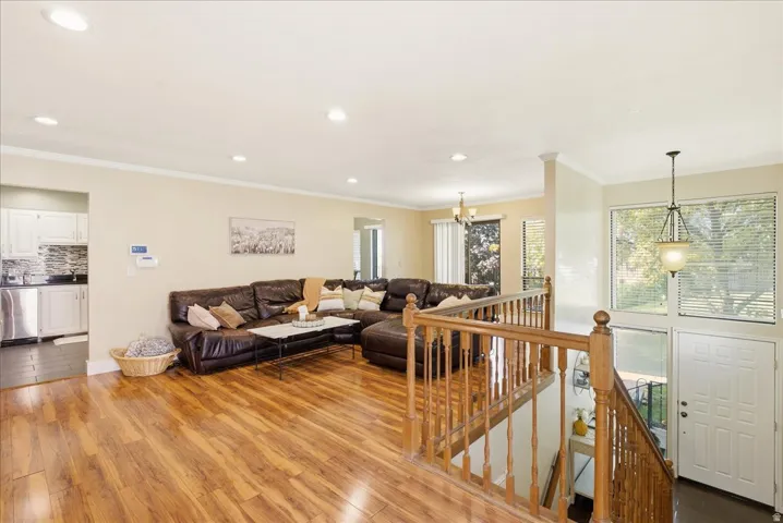 Wood-finish flooring throughout, recessed lighting, and crown molding
