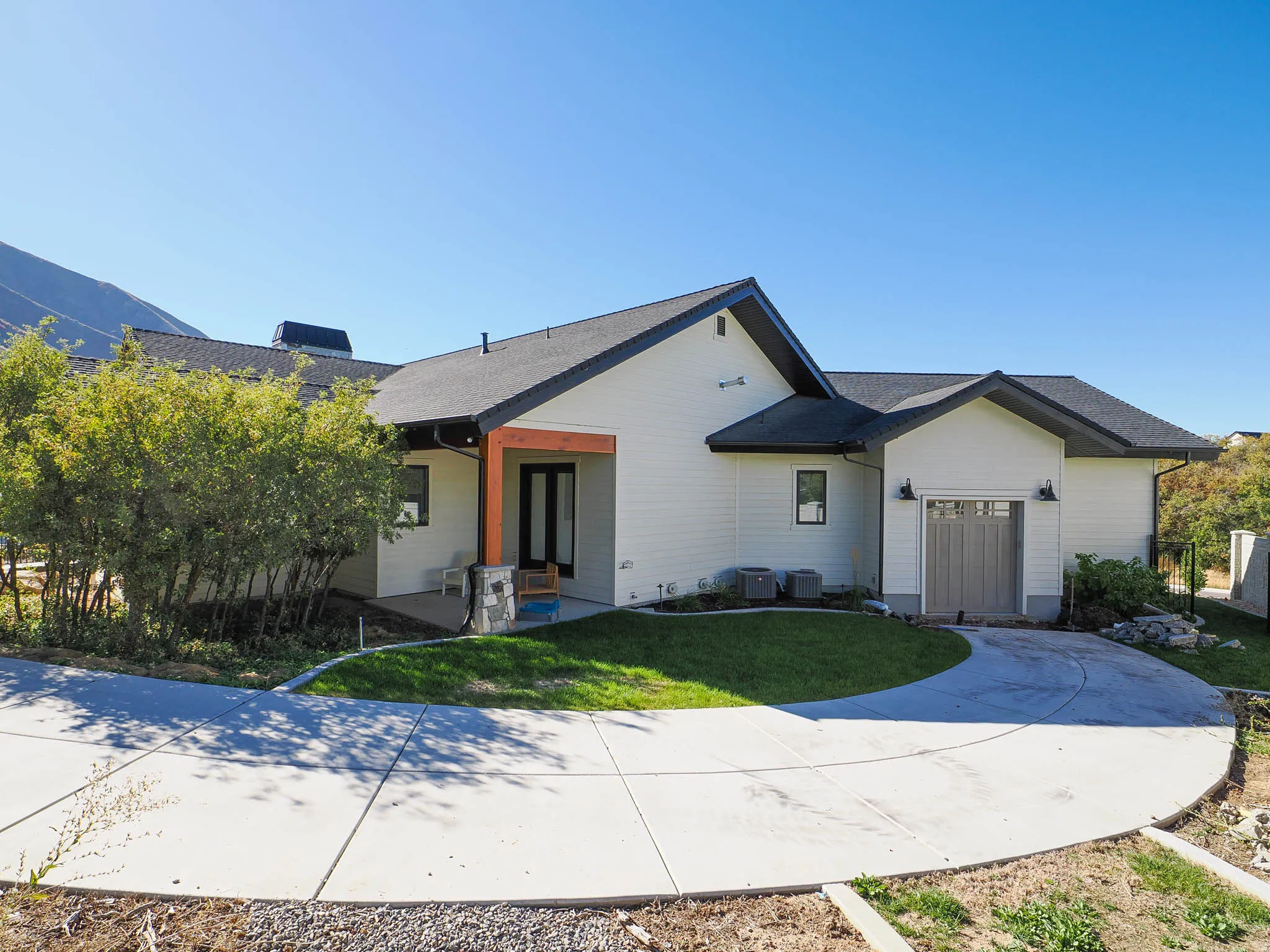 Contemporary exterior with white siding, dark trim, and a dark shingle roof