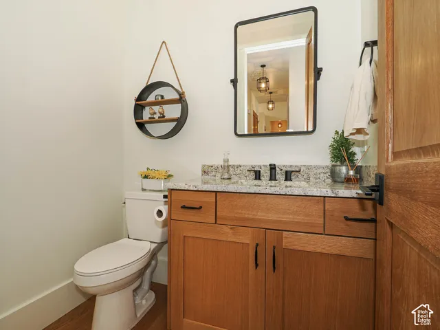 Wood-finish vanity with granite countertop and rectangular sink