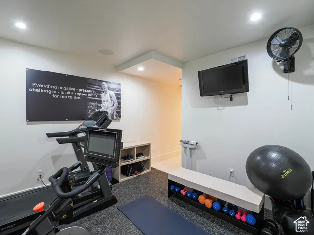 Recessed lighting, wall-mounted television, and a built-in wall fan