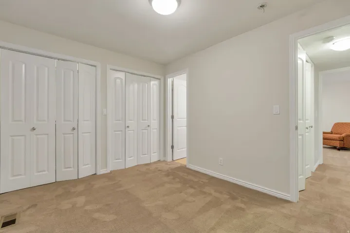 Carpeted flooring paired with neutral wall tones