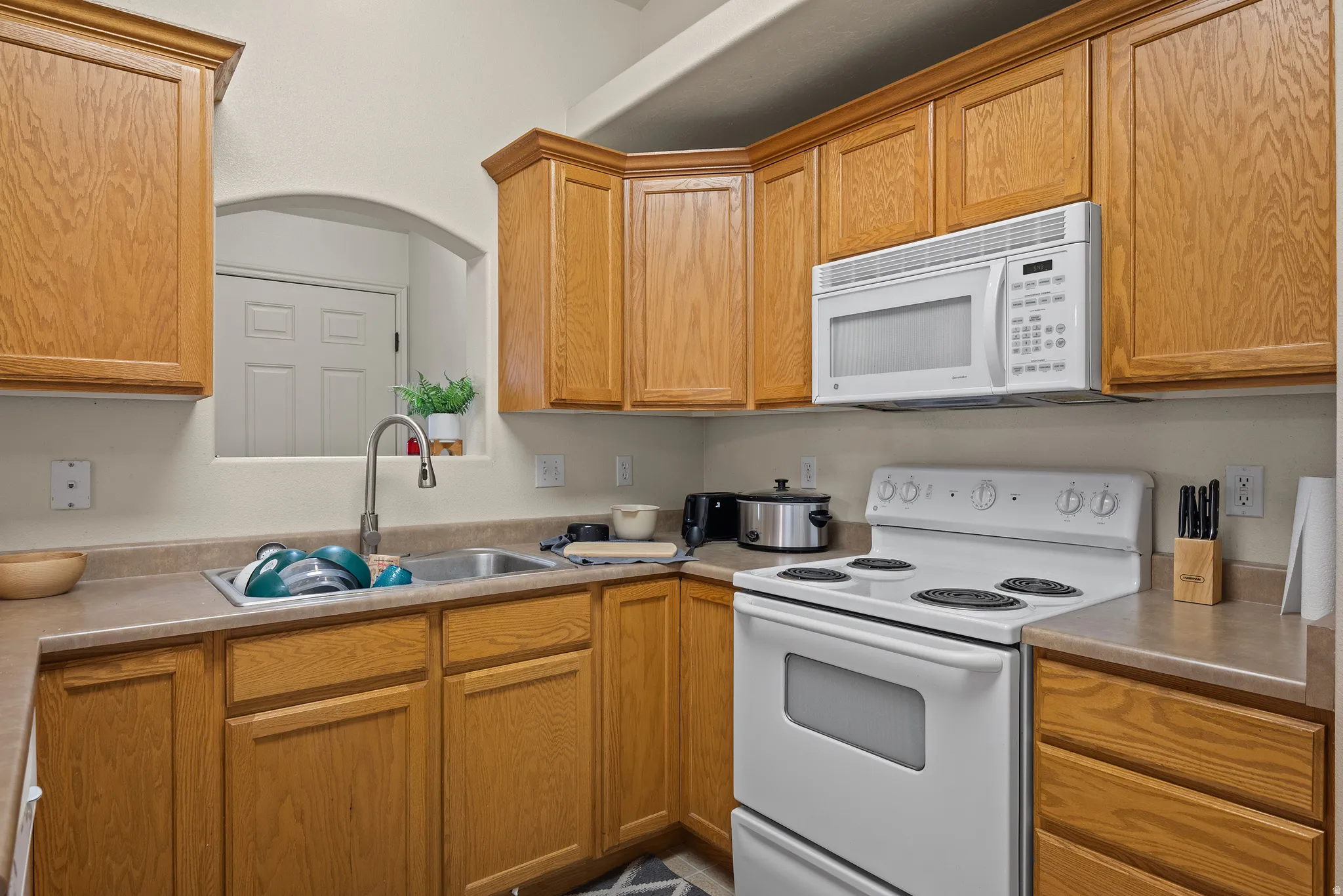 Wood-finish cabinetry paired with light-toned countertops