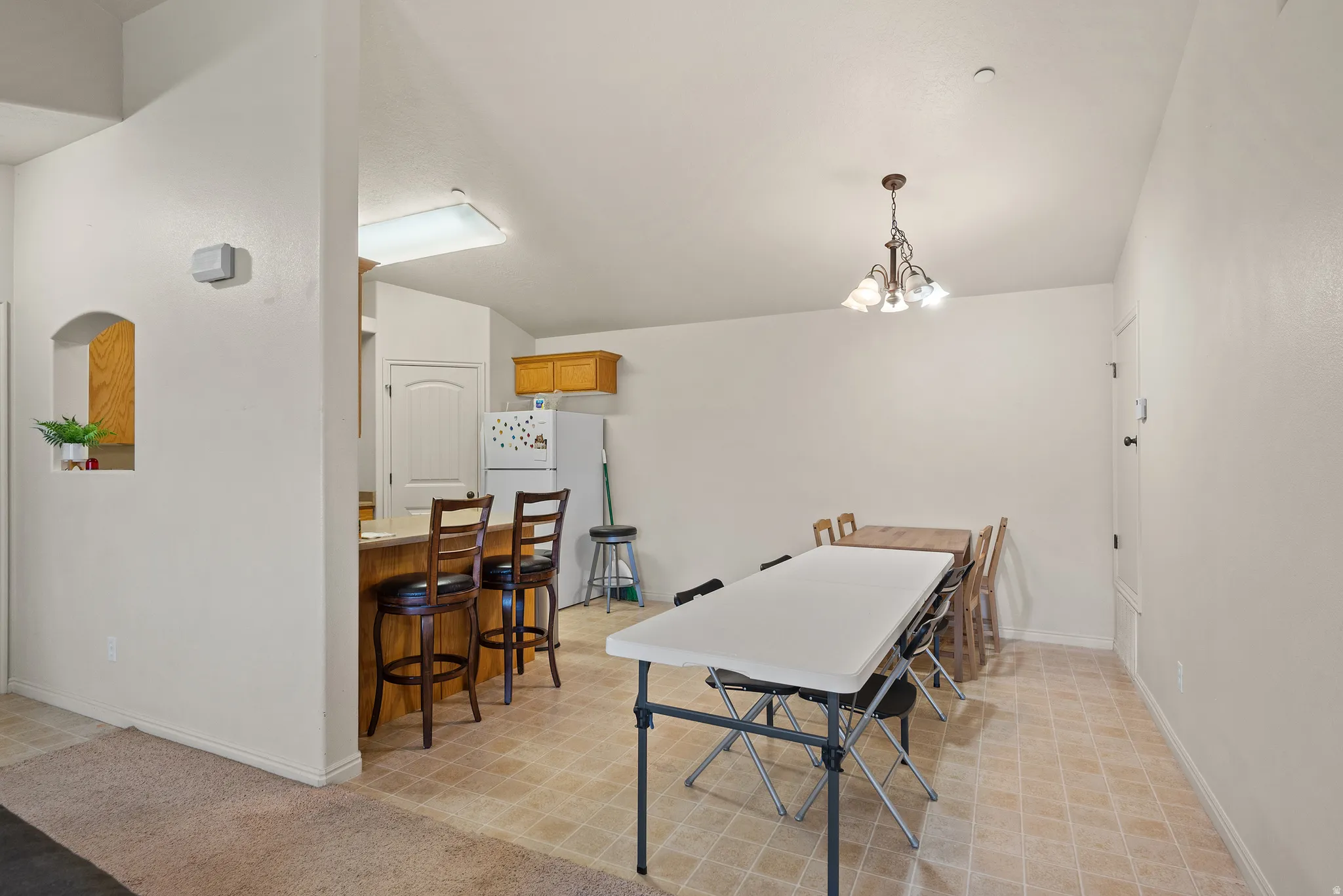 Kitchen featuring wood-finish cabinetry, tile flooring, and a breakfast bar