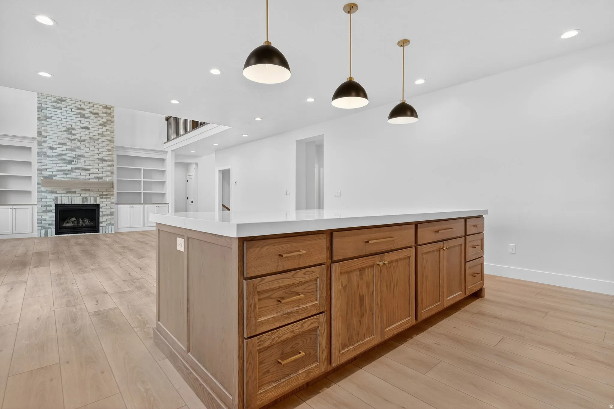 Kitchen island with light-toned wood cabinetry and a white countertop