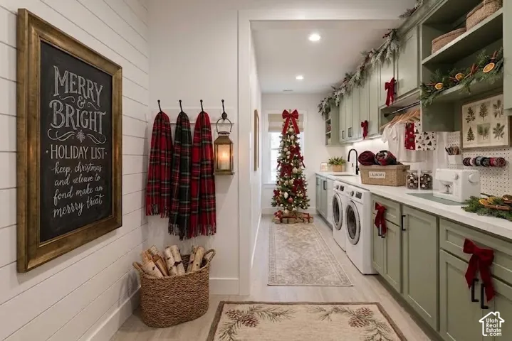 Laundry room with white-finish flooring, light green cabinetry, and white countertops