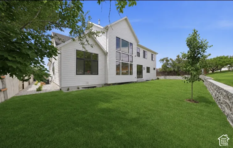 White horizontal siding exterior with a multi-pane window wall