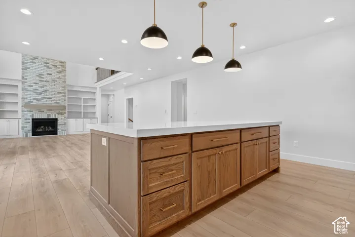 Kitchen island with light-toned wood cabinetry and a white countertop
